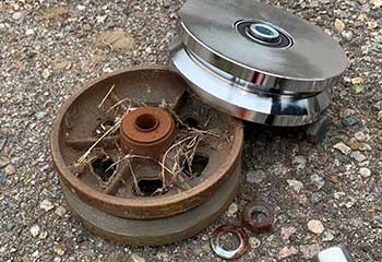 Replacement of old rusty garage cable drum with new precision-machined drum